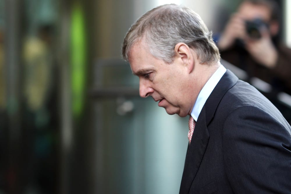 Andrew is walking into a building where we can see a close-up of his profile.