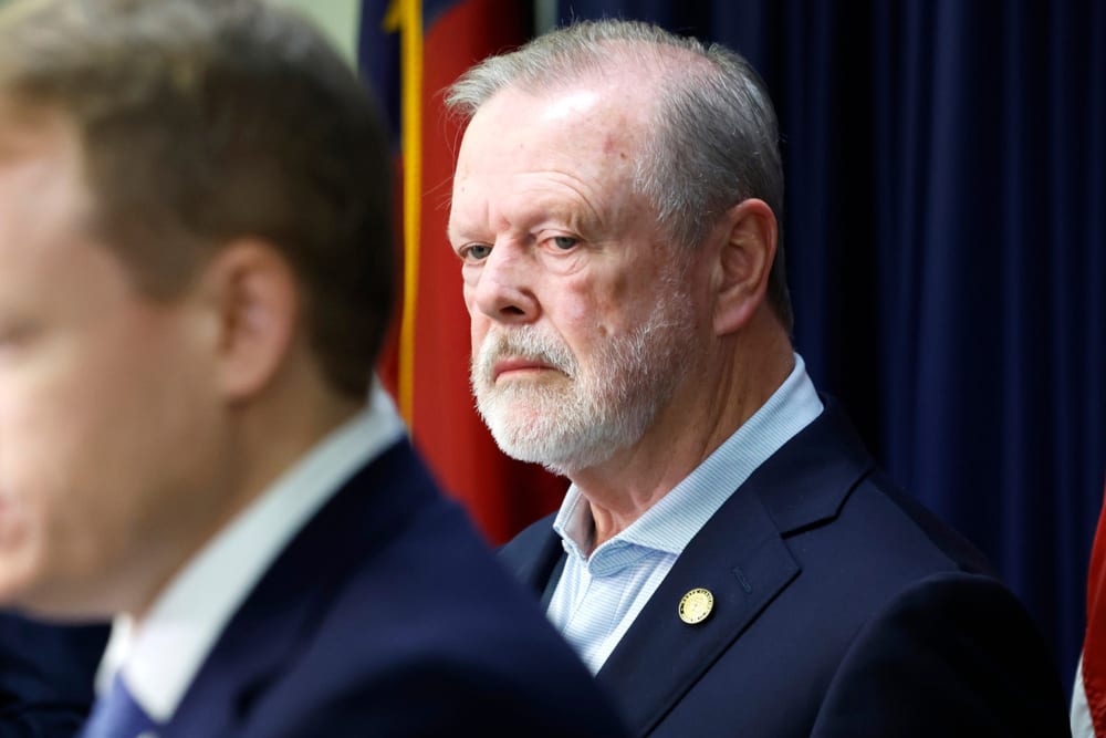 Phil Berger stands behind as he looks on in an upset way.