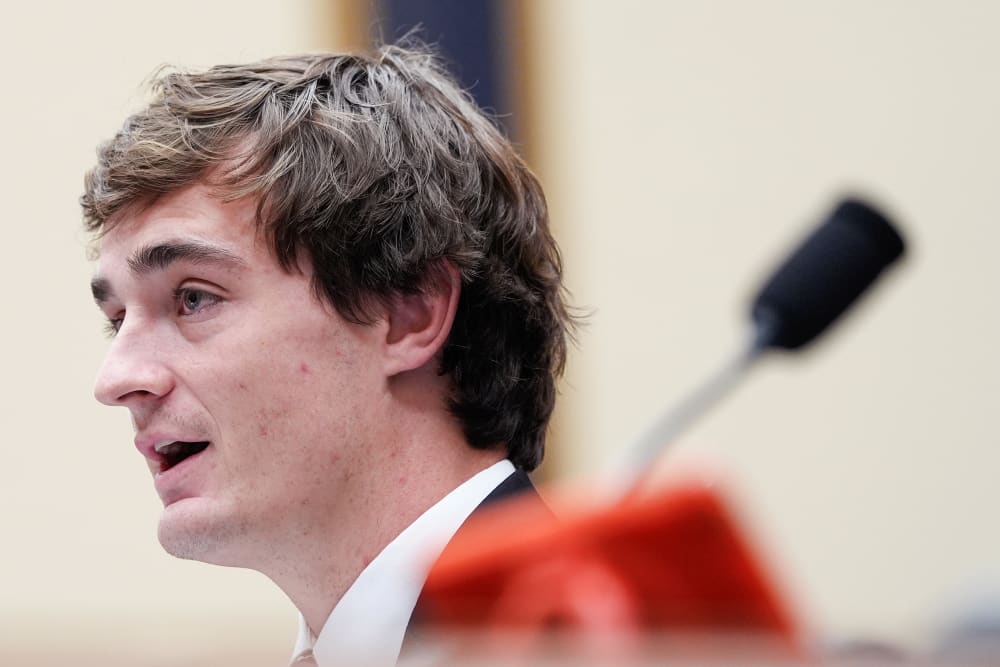 In this very tight shot, Nick Shirley is seen from the side while speaking.