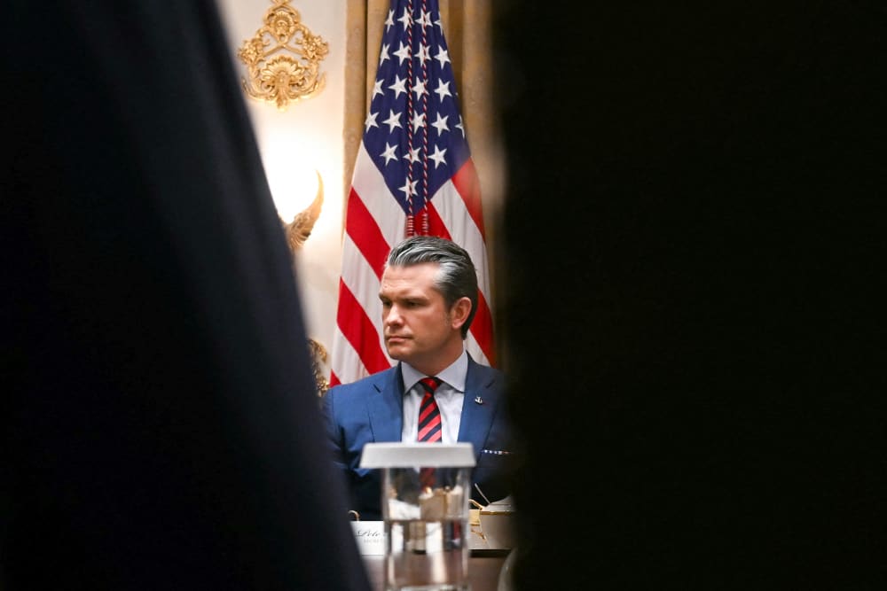 Pete Hegseth is seen looking serious and upset.