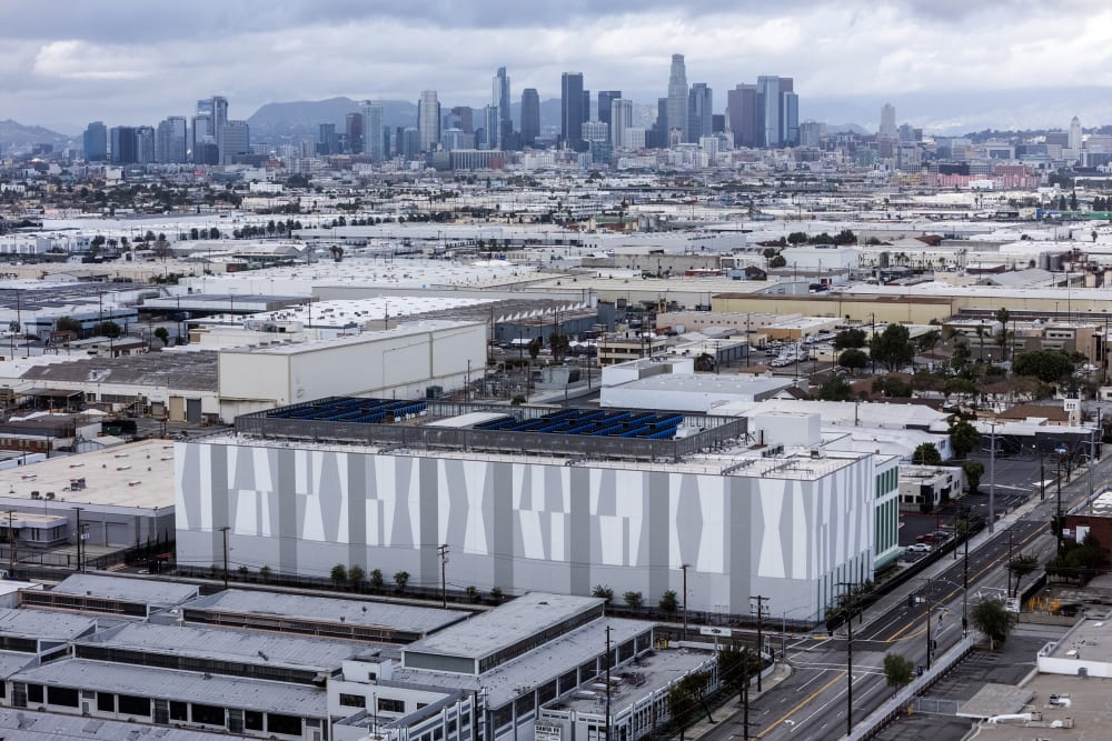 A data center is photographed from above with city skyline in the background.