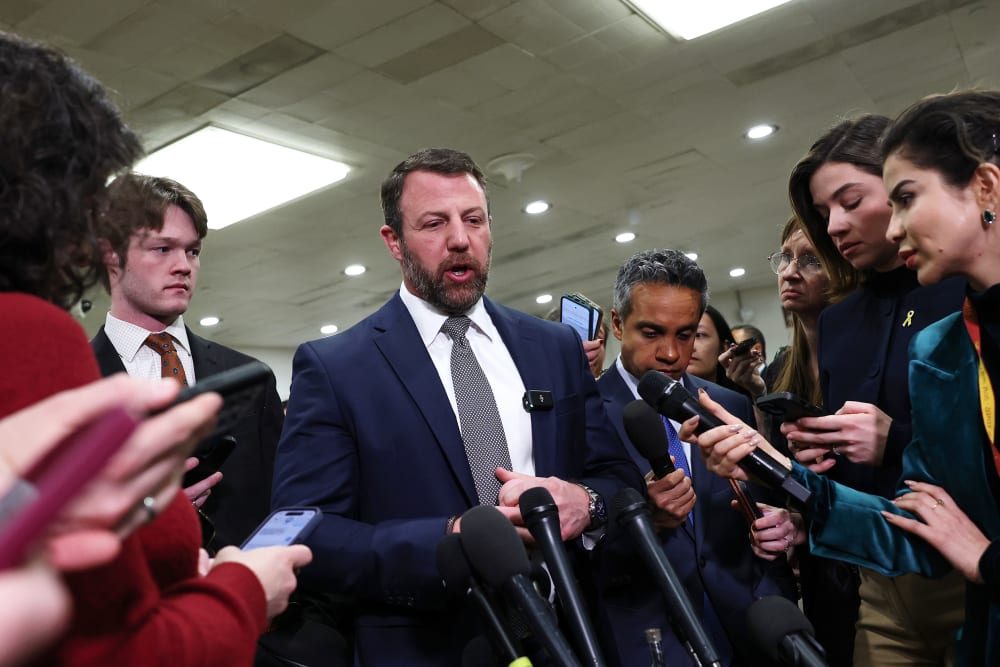 Sen. Mullin is surrounded by journalists at the US Capitol.