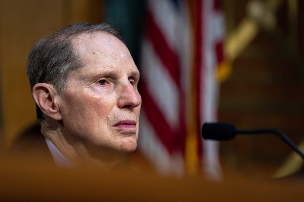 This close up shot shows Ron Wyden sitting as he speaks.