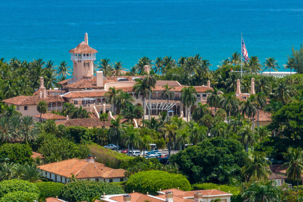 Mar-a-Lago is seen in the distance in front of the sea.