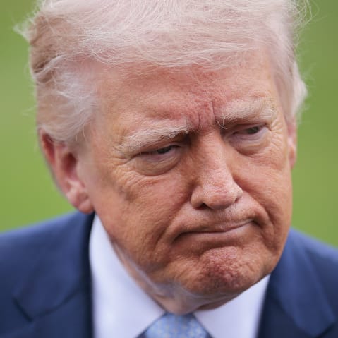 President Donald Trump stops to speak to reporters.