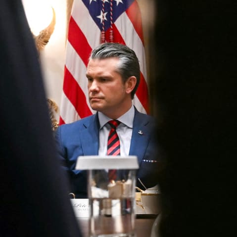 Pete Hegseth is seen looking serious and upset.