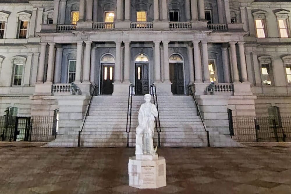 Statue of Christopher Columbus standing in front of the Eisenhower Executive Office Building.