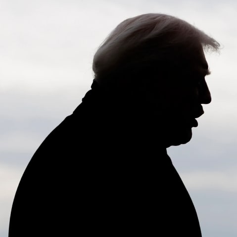 Donald Trump's profile is seen as he speaks and Washington Monument is in the background.
