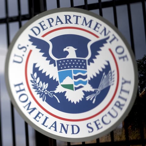 The U.S. Department of Homeland Security seal hangs on a fence at the agency&rsquo;s headquarters in Washington.