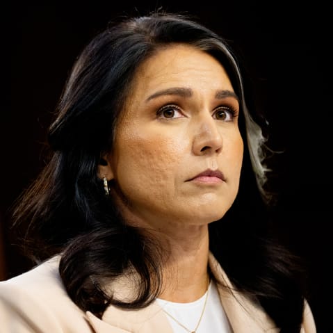 Tulsi Gabbard looking up during a Senate hearing.