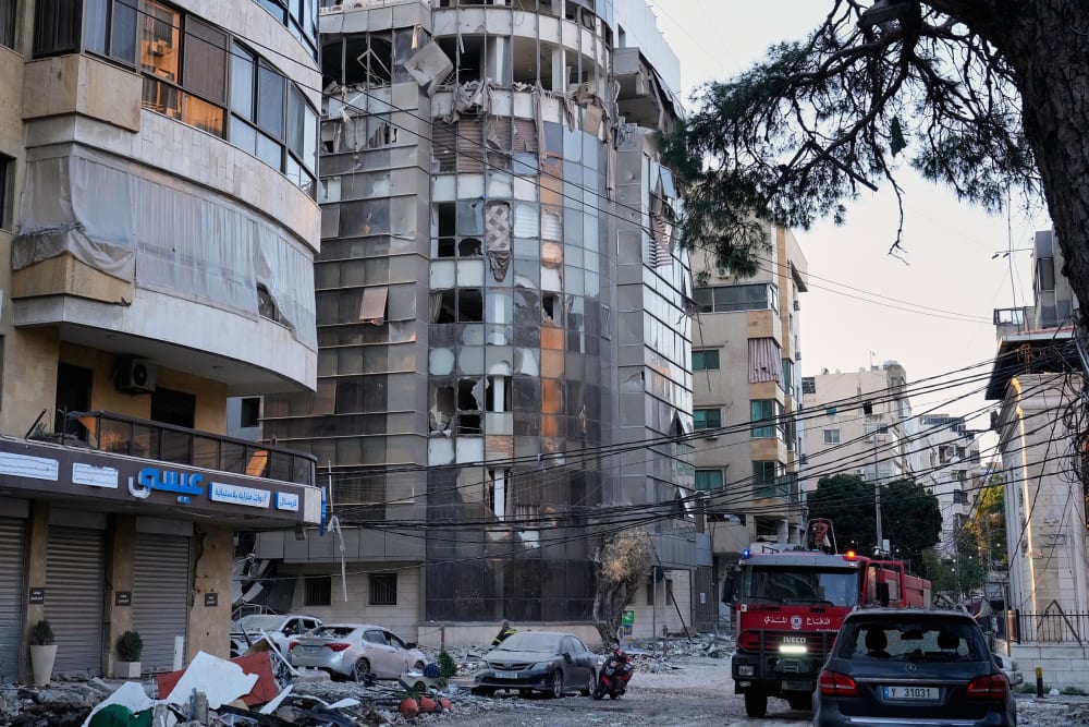 Debris covers a street beside an apartment building hit by an Israeli airstrike in Dahiyeh, Beirut's southern suburb.