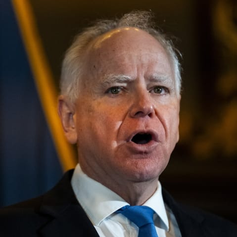 Gov. Tim Waltz speaks at the podium during a presser.