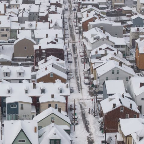 An aerial view of snow-covered homes.