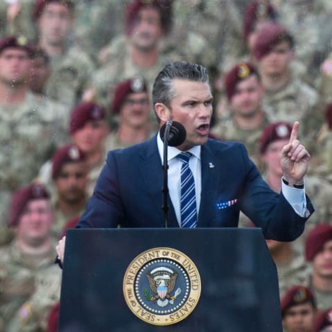 Pete Hegseth in front of a crowd of soldiers.