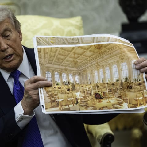 President Donald Trump speaks holding a rendering of the new ballroom