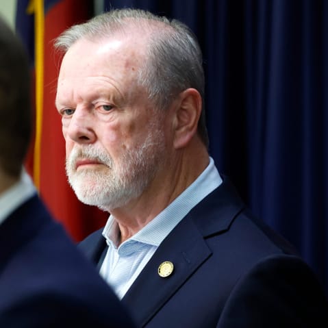 Phil Berger stands behind as he looks on in an upset way.