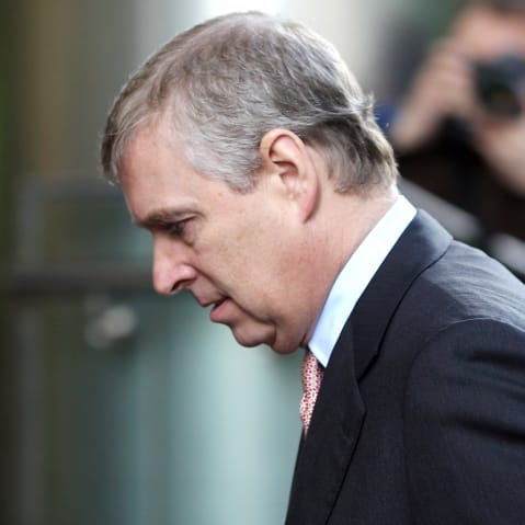 Andrew is walking into a building where we can see a close-up of his profile.