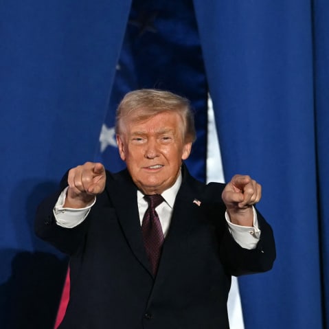 U.S. President Donald Trump steps on stage to speak at a political rally.