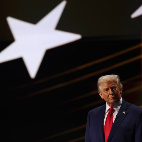 Donald Trump under a projection of a star.