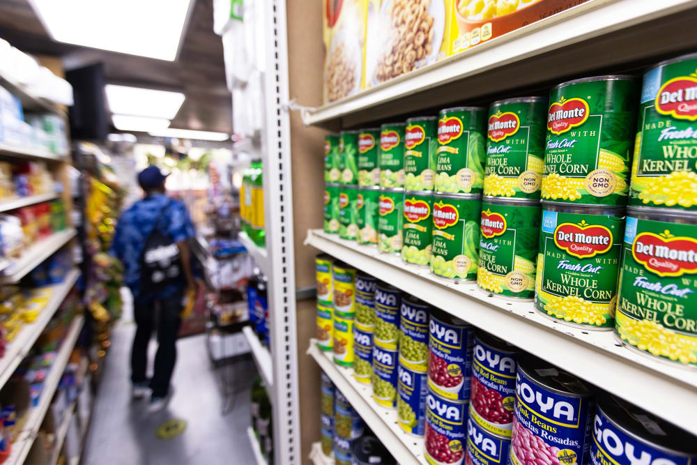 Canned food and other products in an aisle at a grocery store in NY