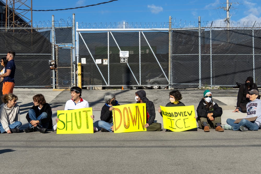Protesters and activists sit in front of a gate to the Immigration and Customs Enforcement facility on Sept. 5, 2025 in Broadview, IL.
