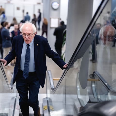 Bernie Sanders going up the escalators.