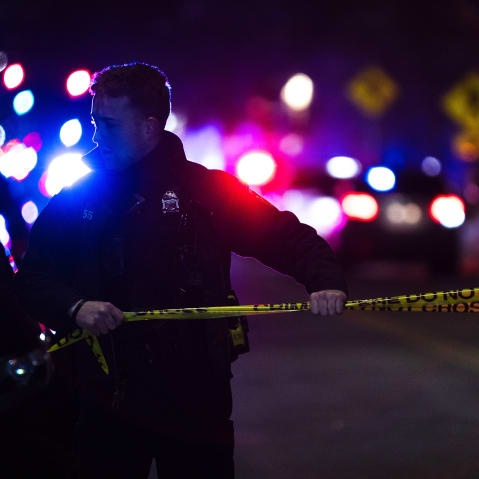 Police officers remain holds crime scene tape at Brown University.