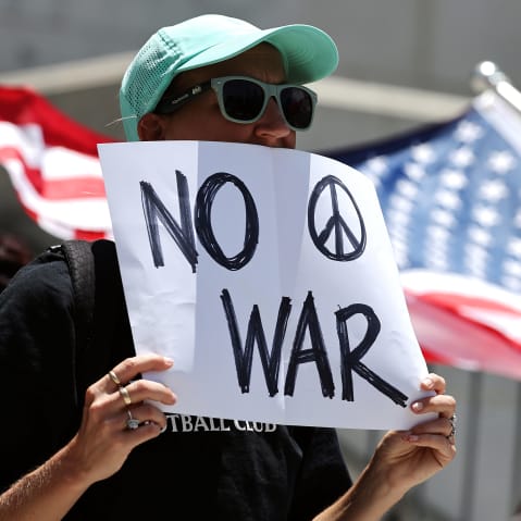 Demonstrators gather outside City Hall during a rally opposing the United States' strikes on Iran on June 22, 2025.