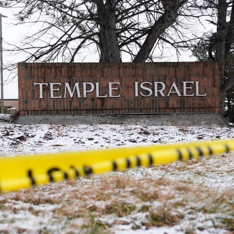 Police tape hangs outside the Temple Israel synagogue.