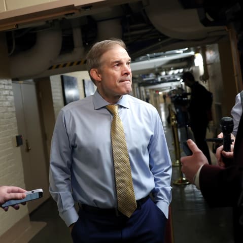 Jim Jordan has his hands in his pockets while speaking to the reporters.