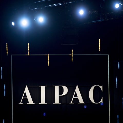 The word AIPAC is seen on a black background.