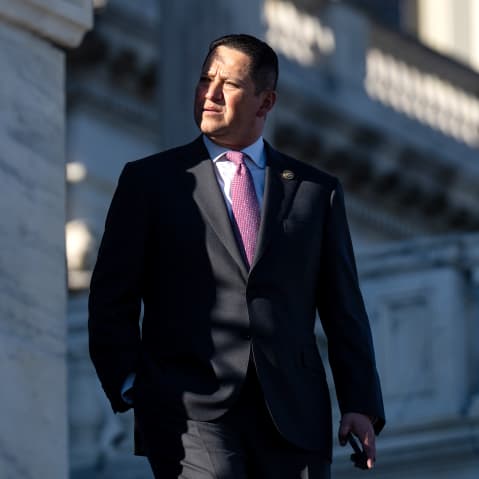 Tony Gonzales looks away as he walks down the steps where a small part of his face is in shade.
