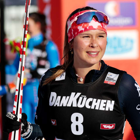 Annika Malacinski smiles with her ski outside.