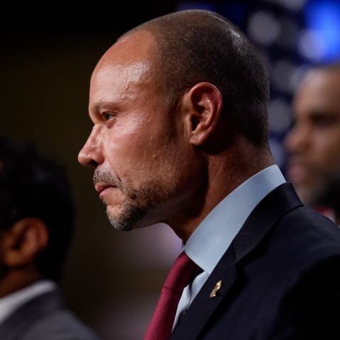 Don Bongino looks on the right side of the frame during a press conference.