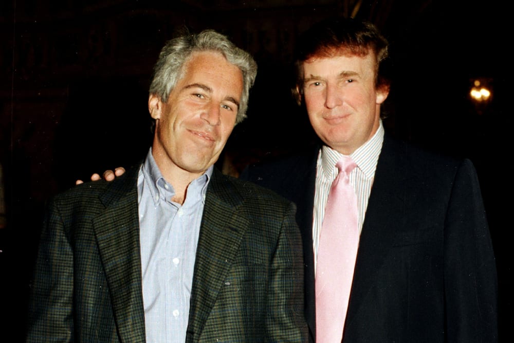 Epstein and Trump pose for a portrait together while Trump has his right hand over Epstein's shoulder.