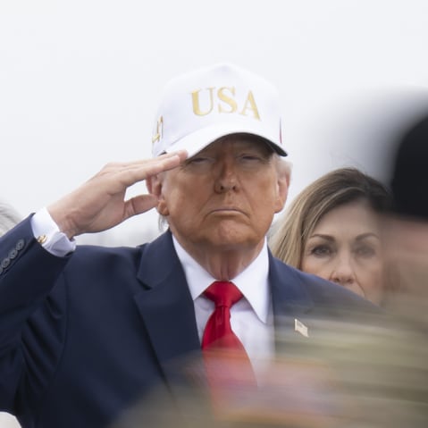 President Donald Trump salutes as a U.S. Army carry team moves a flag-draped transfer case.