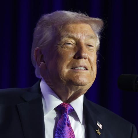 Donald Trump speaks at the podium.