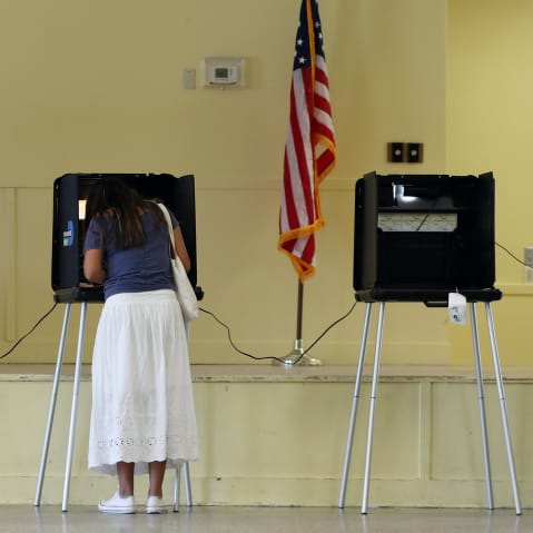 Woman fills out her ballot as she votes on Nov. 03, 2020 in Miami.