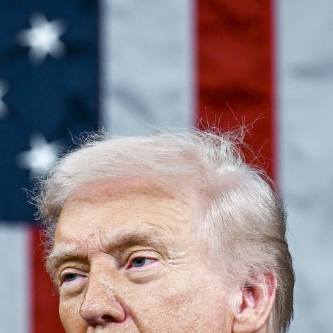 President Donald Trump with the US flag behind him.