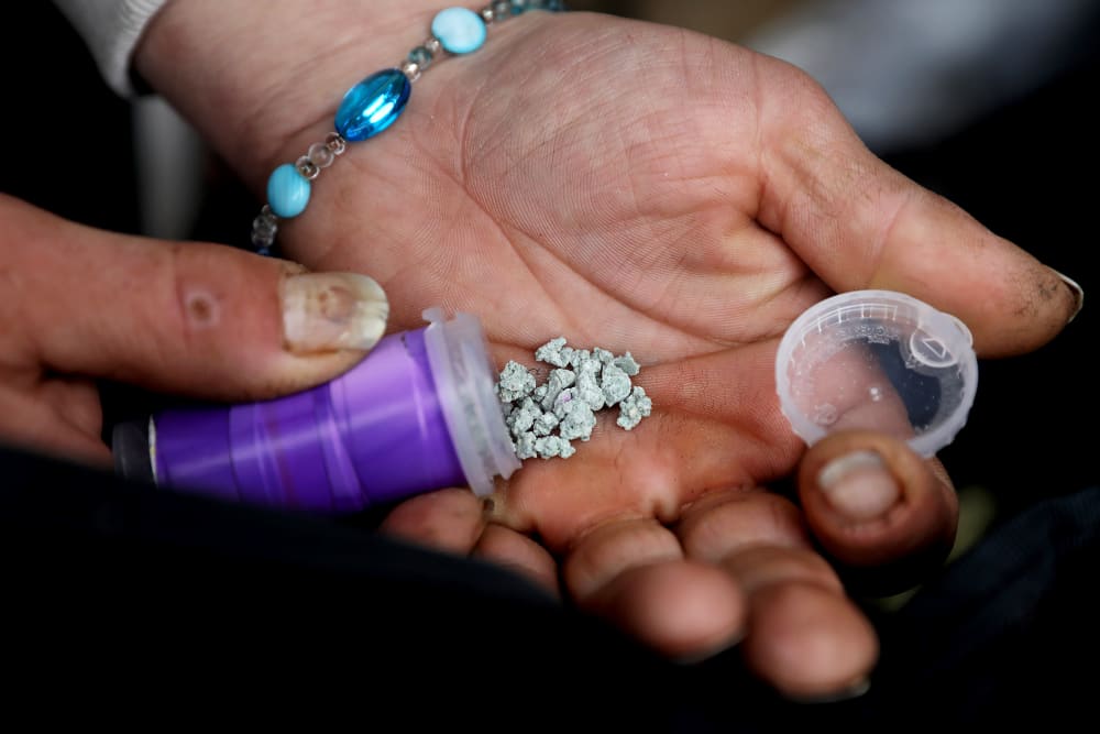 A man shows an eight ball, or 3.5 grams, of fentanyl.