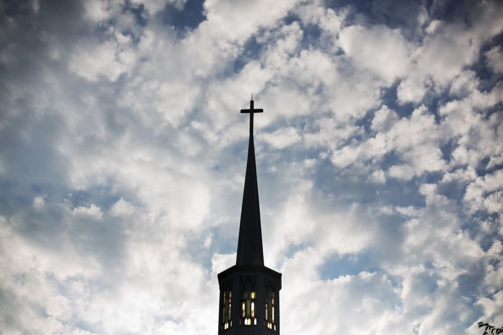 The sun rises behind the steeple of a church, Aug. 23, 2015, in Plains, Ga. (Photo by David Goldman/AP)