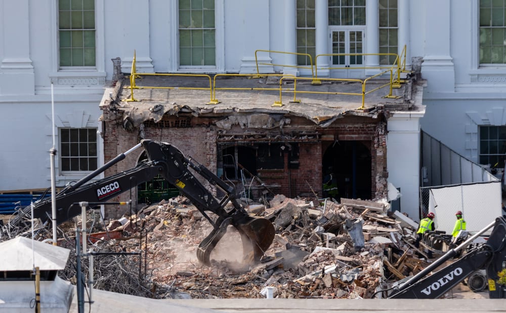 An excavator works to clear rubble after the East Wing of the White House was demolished.
