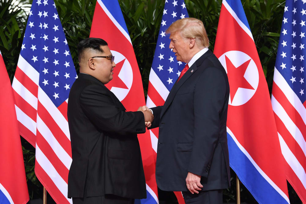 Image: North Korea's leader Kim Jong Un shakes hands with President Donald Trump