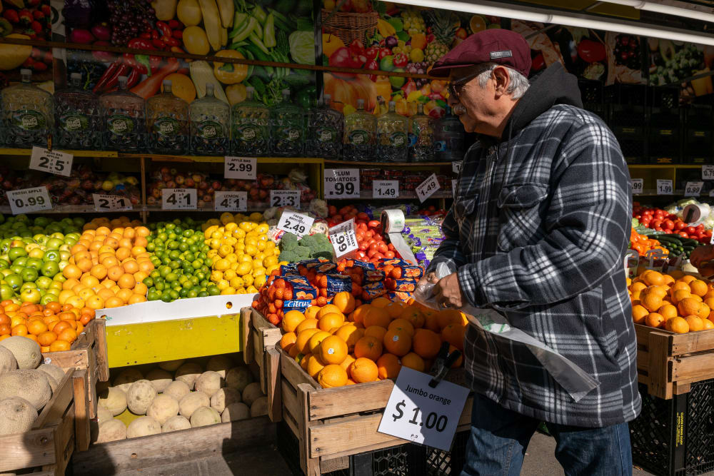 A man walks by a food market in New York City.