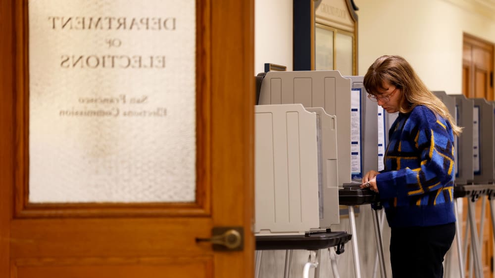 A voter fills out their ballot inside San Francisco City Hall.