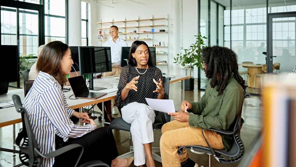 Three creative colleagues exchanging ideas