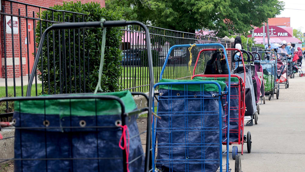 Carts lined up to reserve people’s places in line for meals.