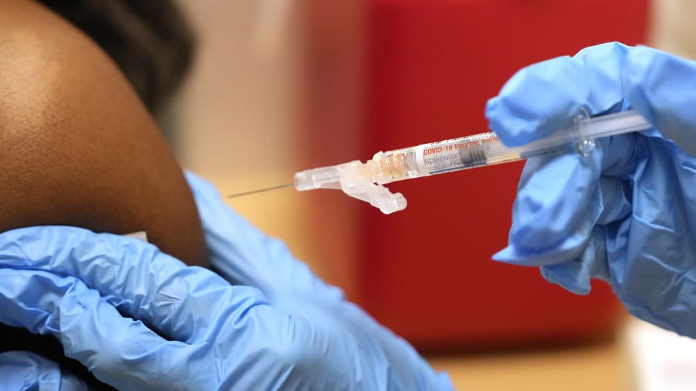 A pharmacist gives a COVID-19 vaccine in Cypress, Texas in 2023.