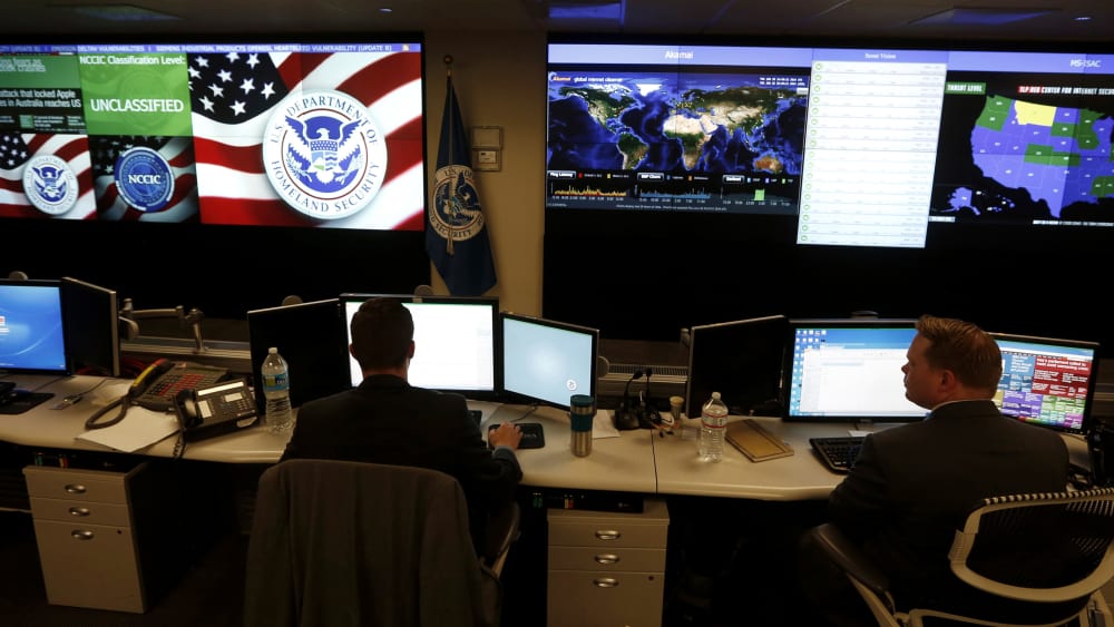US Department of Homeland Security employees work in front of US threat level displays inside the National Cybersecurity and Communications Integration Center as part of a guided tour in Arlington, Va. June 26, 2014. (Photo by Kevin Lamarque/Reuters)