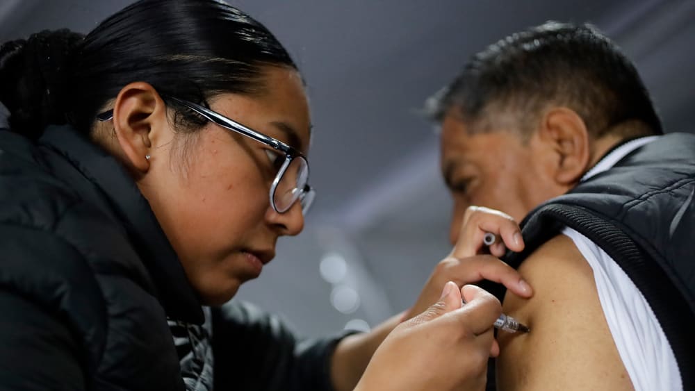 A health worker administers a vaccine during a mass vaccination campaign in Mexico City, Mexico.